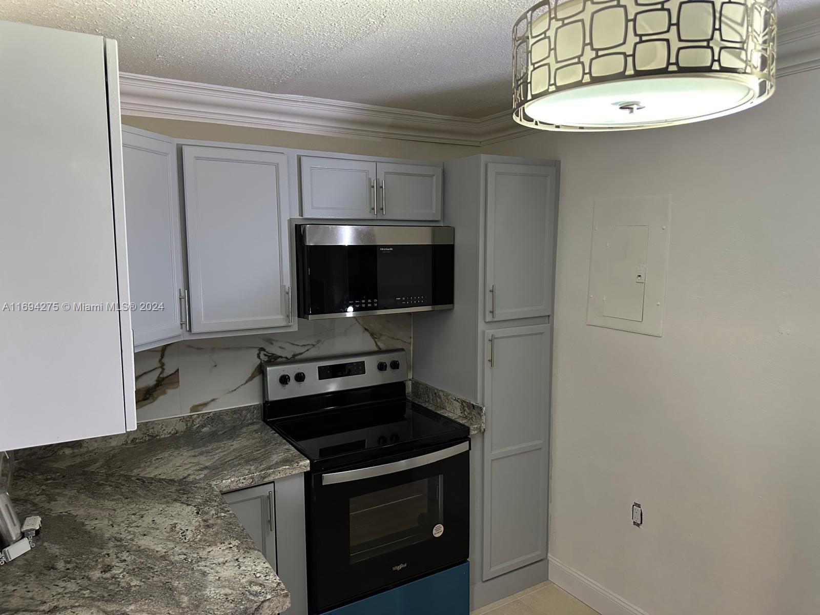 a kitchen with a stove and a microwave