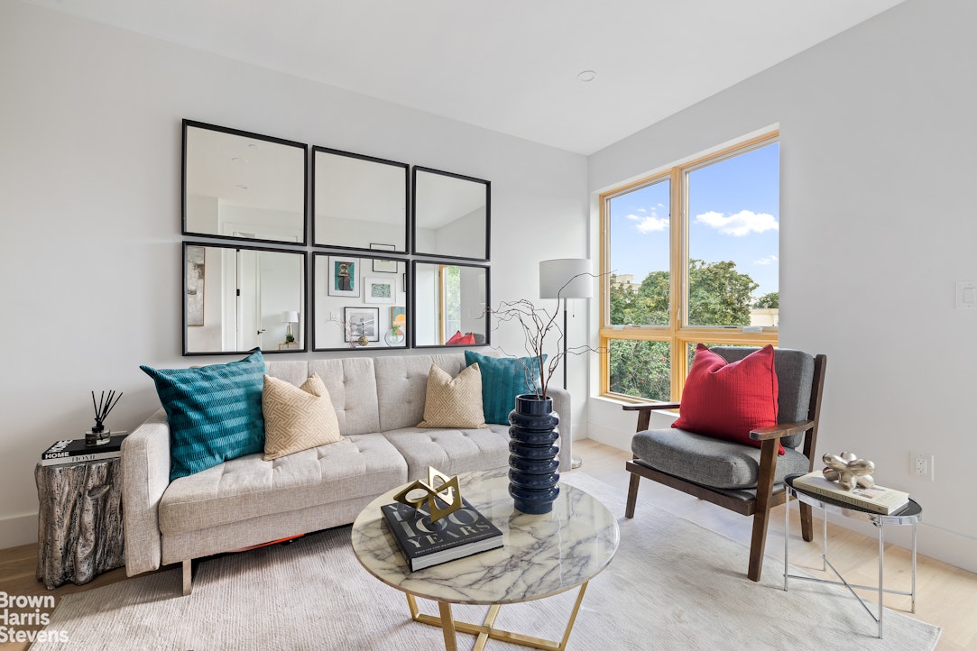 a living room with furniture and a floor to ceiling window