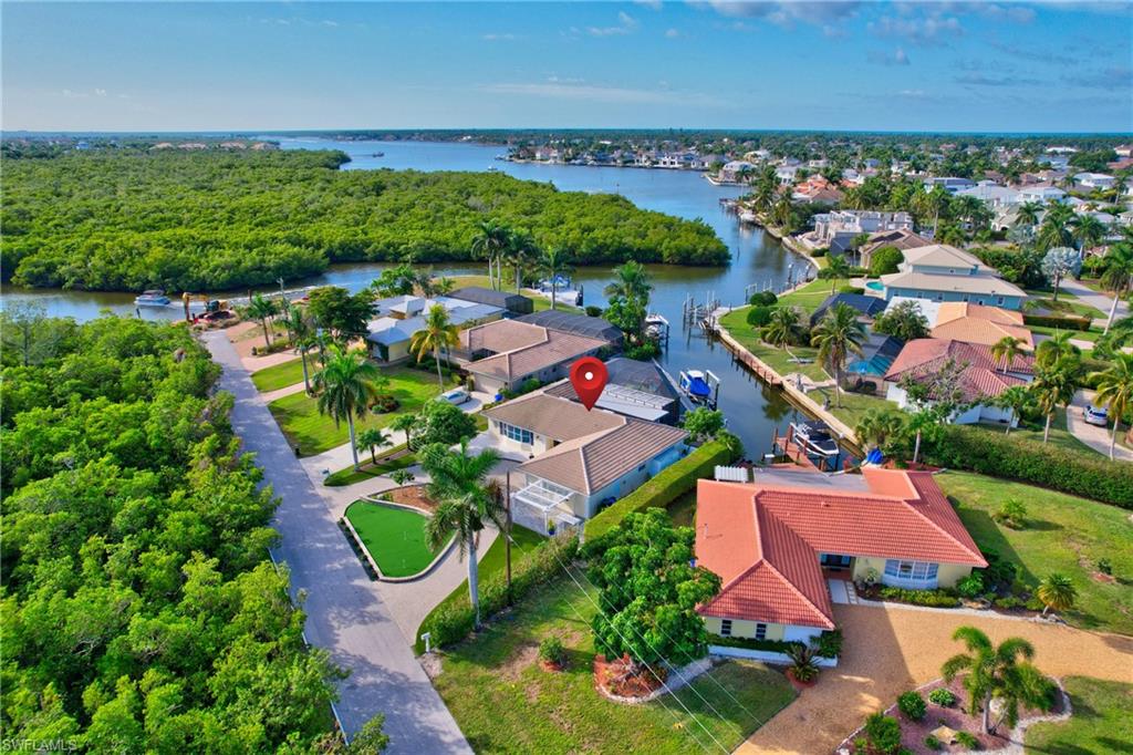 an aerial view of residential houses with outdoor space and lake view