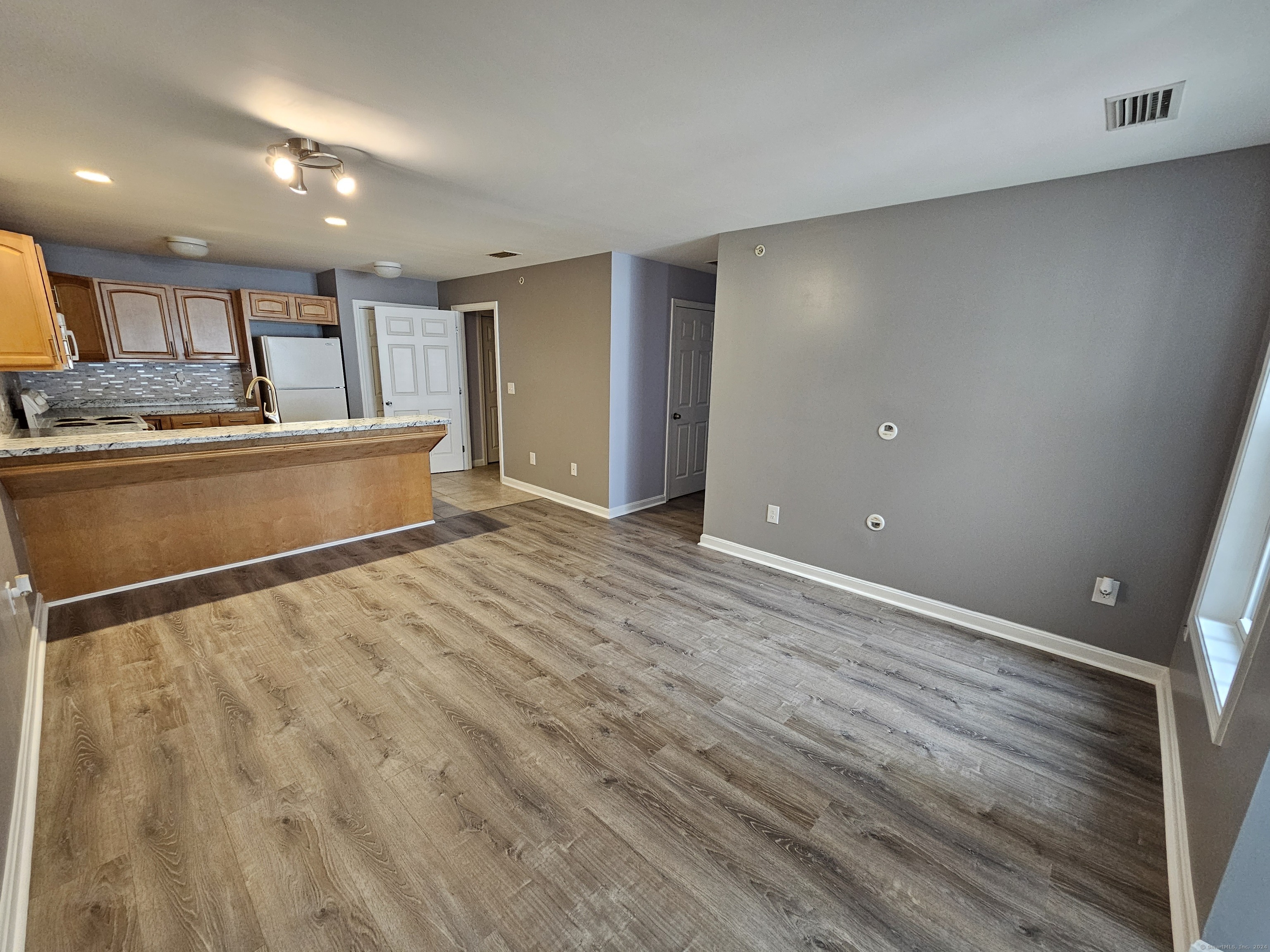 a view of kitchen with wooden floor