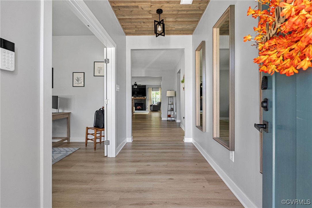 Entryway featuring wood ceiling and light hardwood