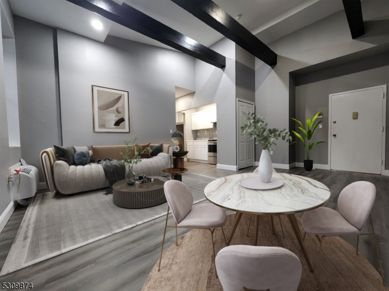 a living room with furniture potted plant and a table