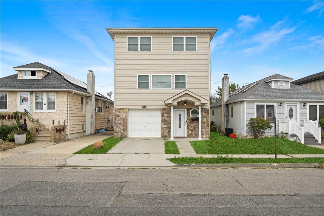 View of front of property with a garage