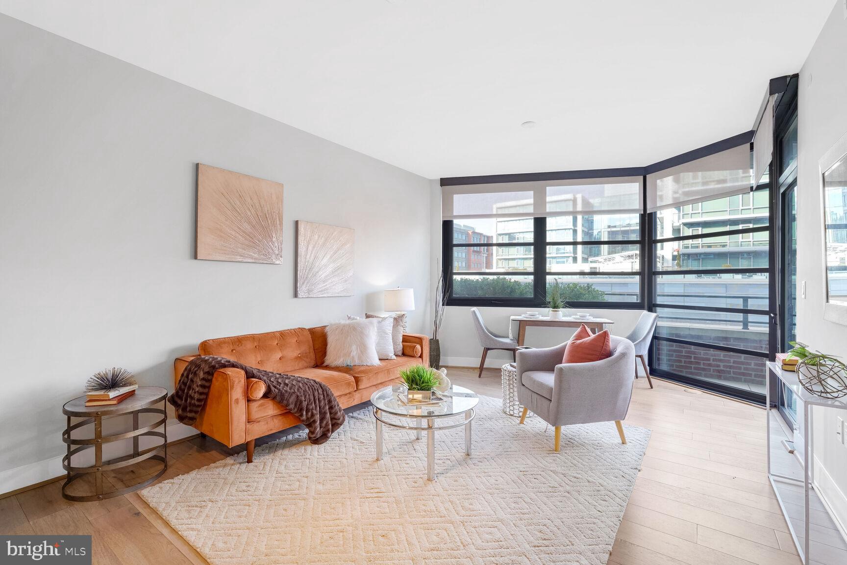 a living room with furniture and a floor to ceiling window