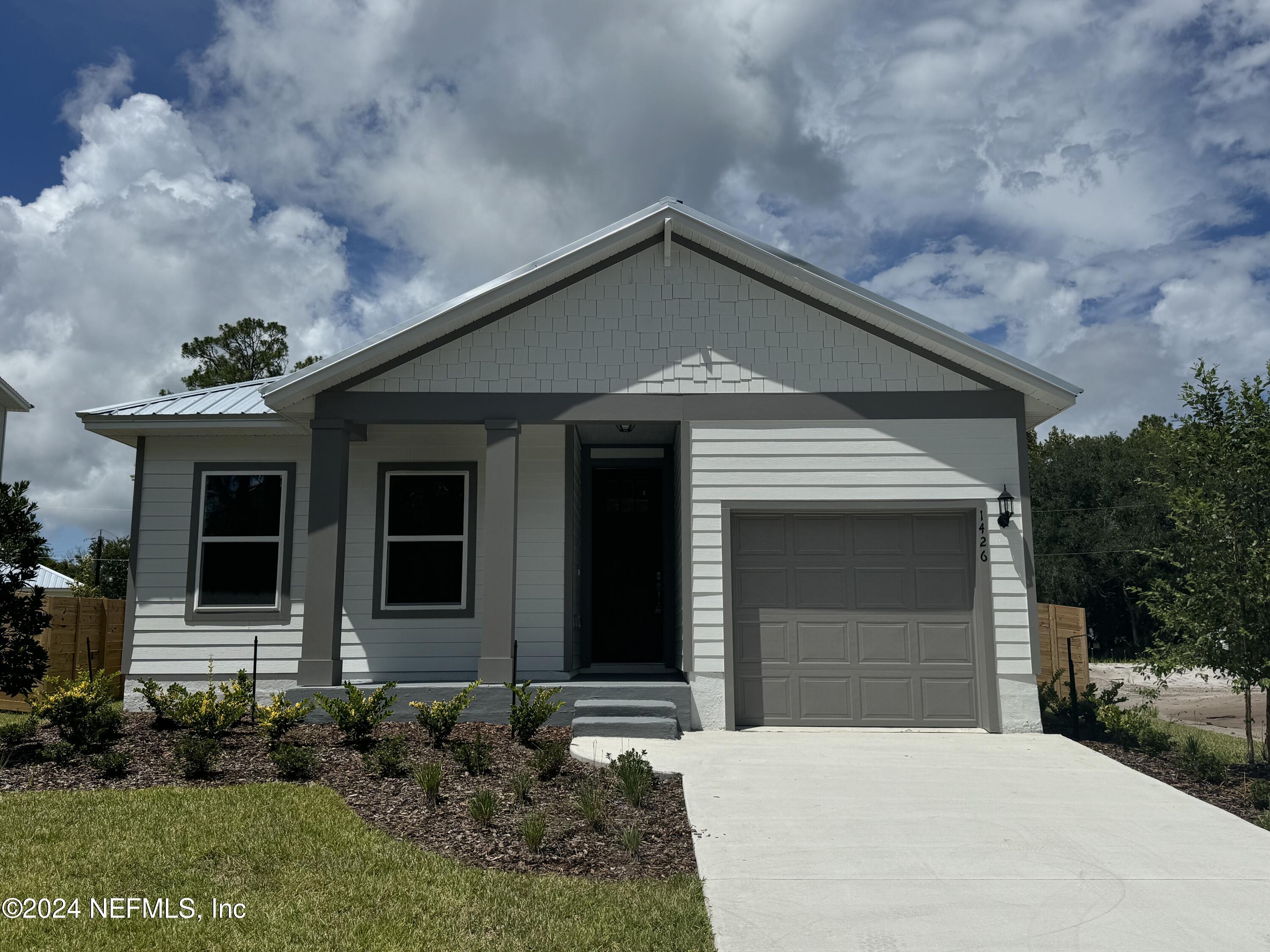 a front view of a house with garden