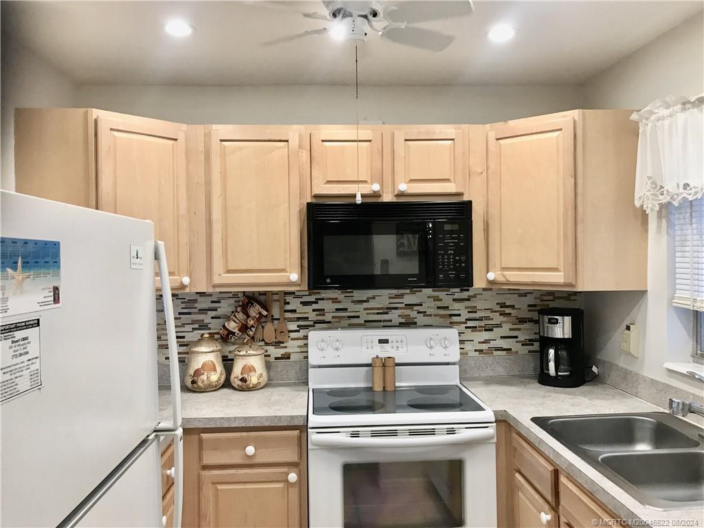 a kitchen with a stove a sink and a microwave