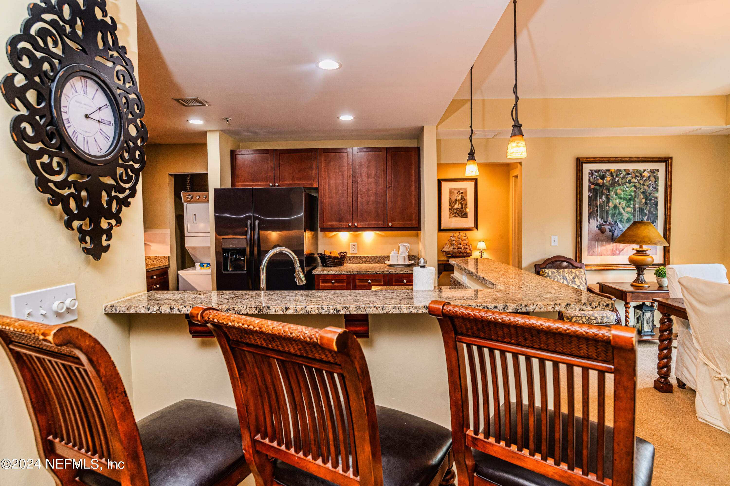 a living room with furniture a clock and a fireplace