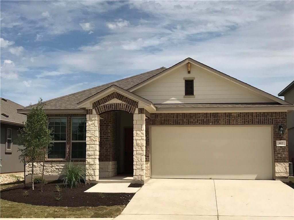 a front view of a house with a garage