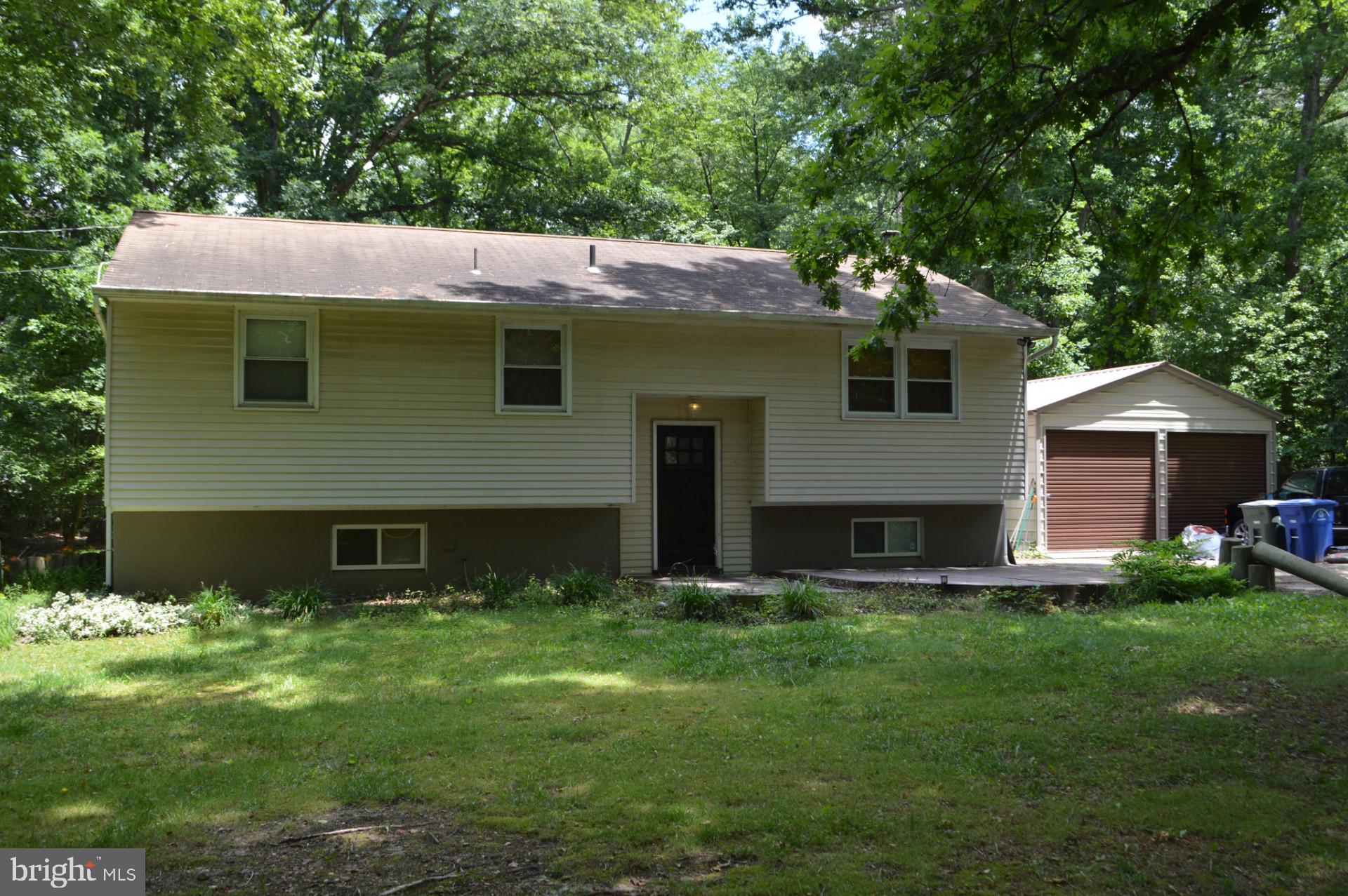 a view of a house with a yard and sitting area