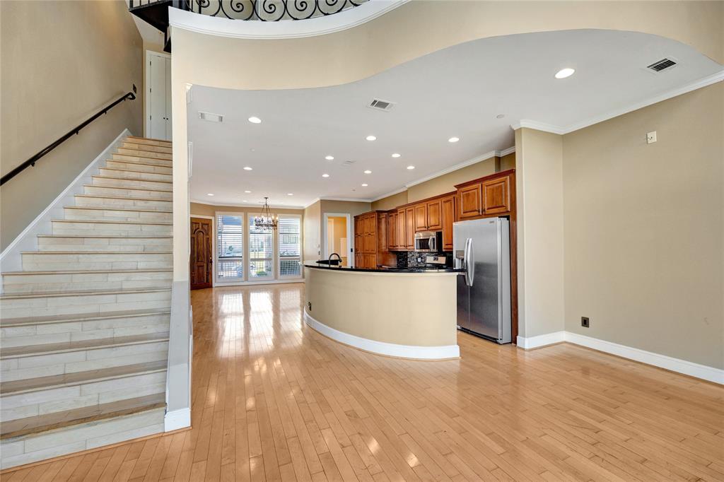 a view of a kitchen with a refrigerator and a floor to ceiling window