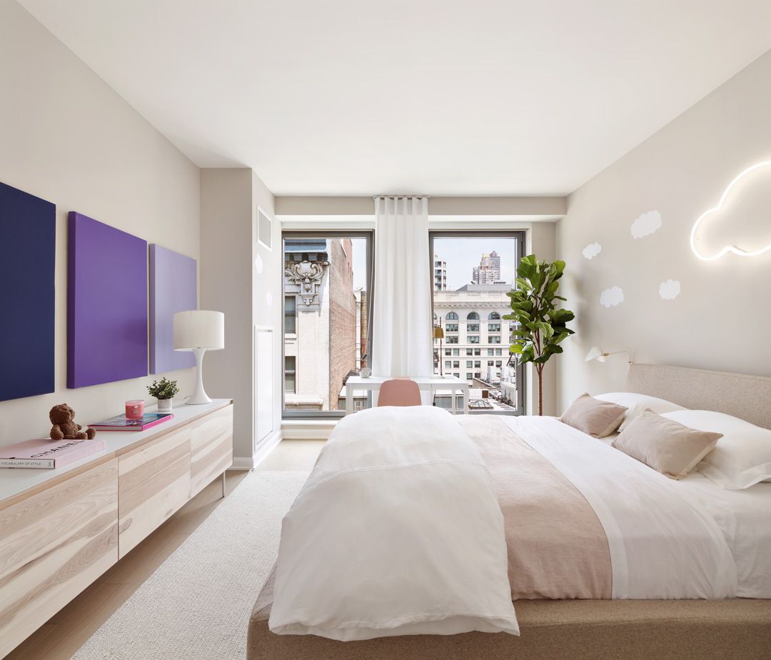 a bedroom with a bed table and window