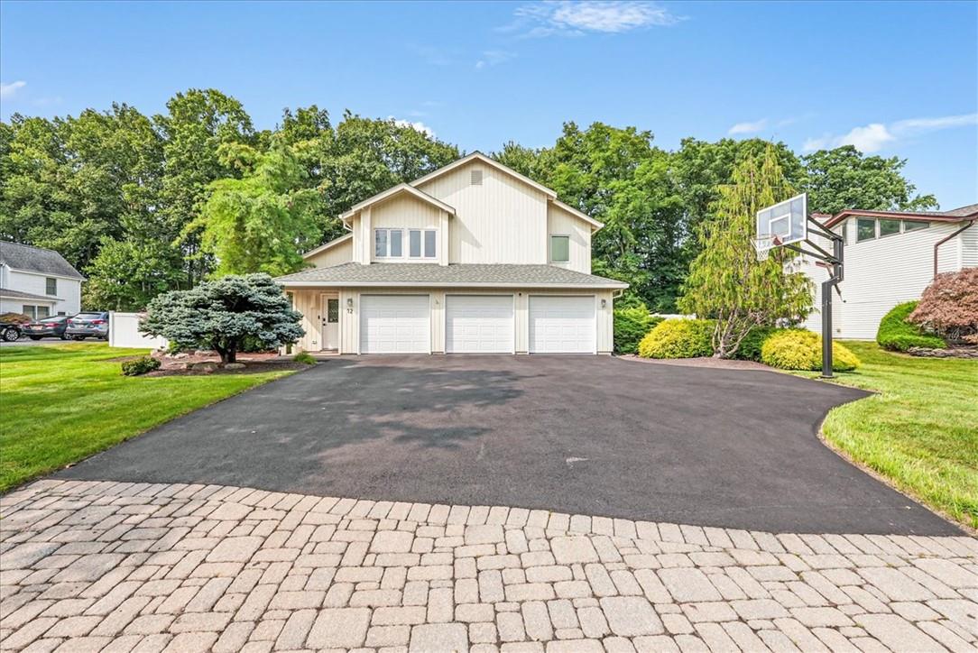 Front of property featuring a garage and a front lawn