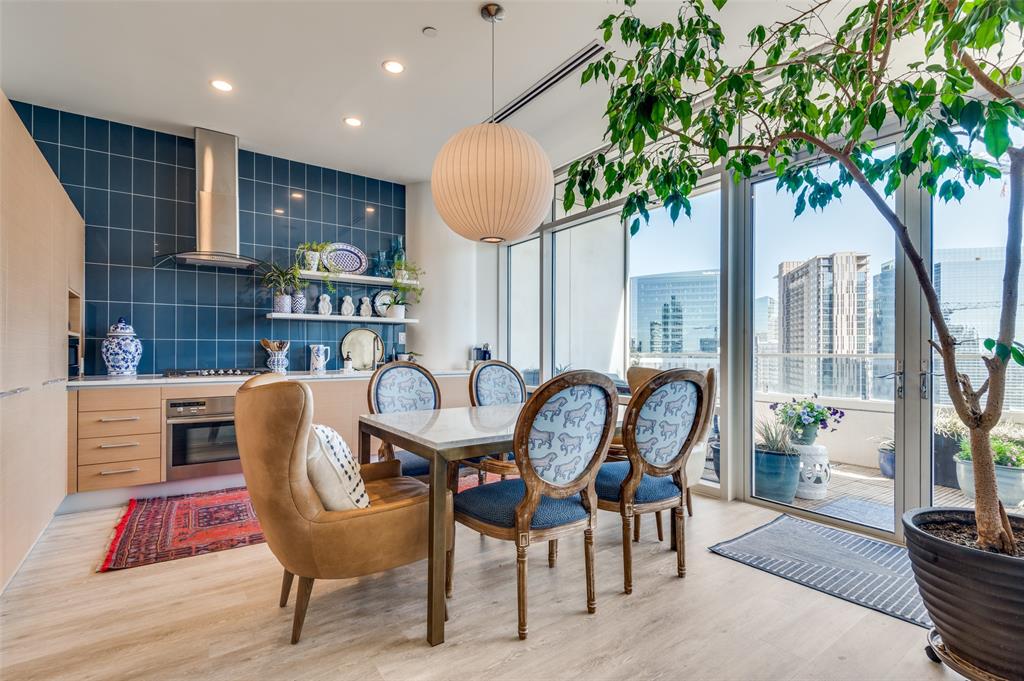 a dining room with furniture and a potted plant