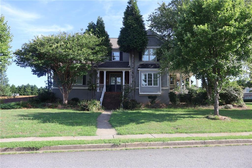 a front view of a house with a yard