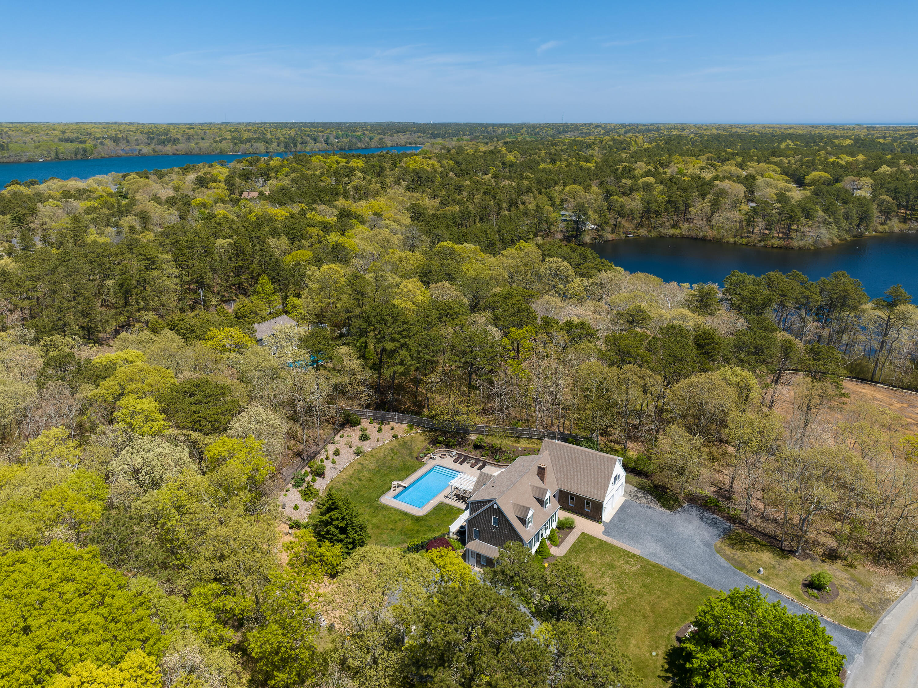 an aerial view of a houses with a lake