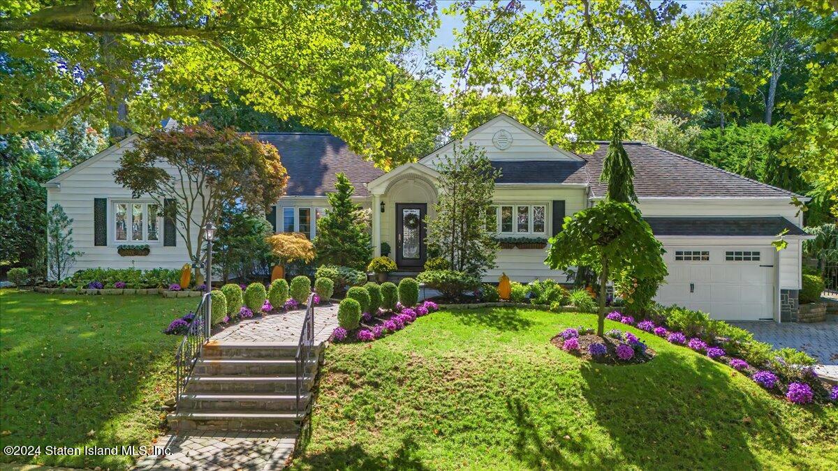 a front view of a house with a yard and fountain