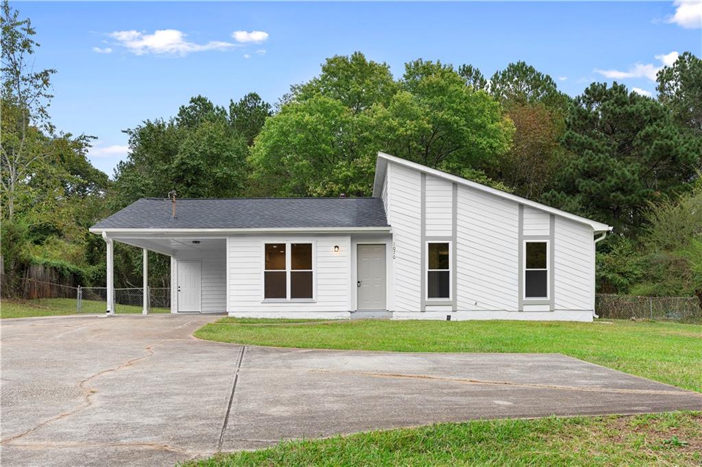 a view of front of house with a yard