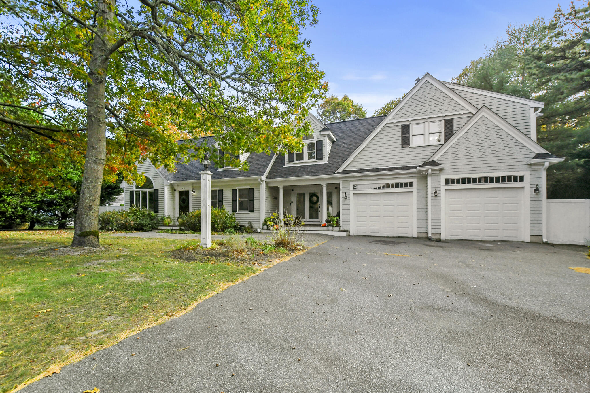 a front view of a house with a yard and porch