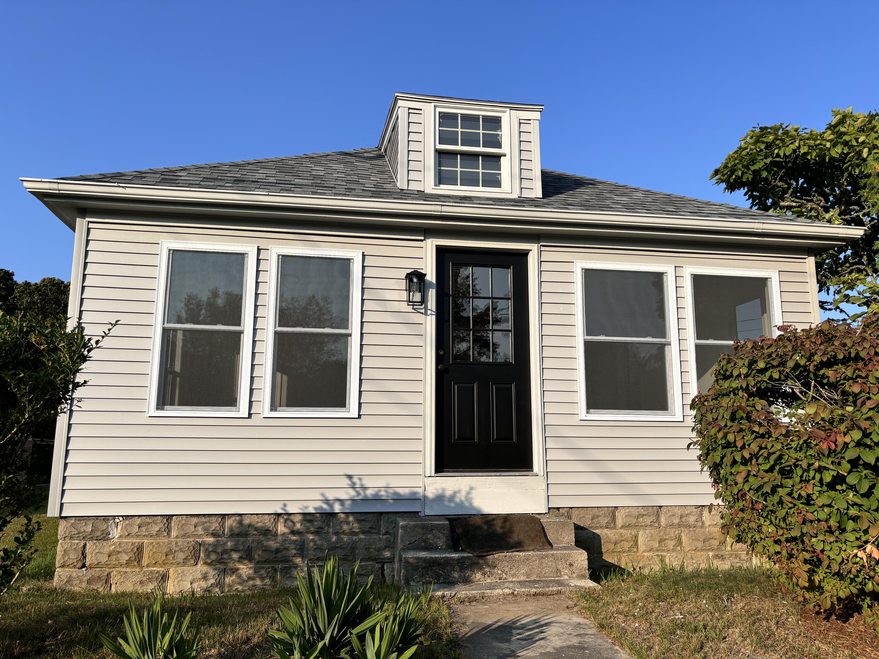 a front view of a house with a garden