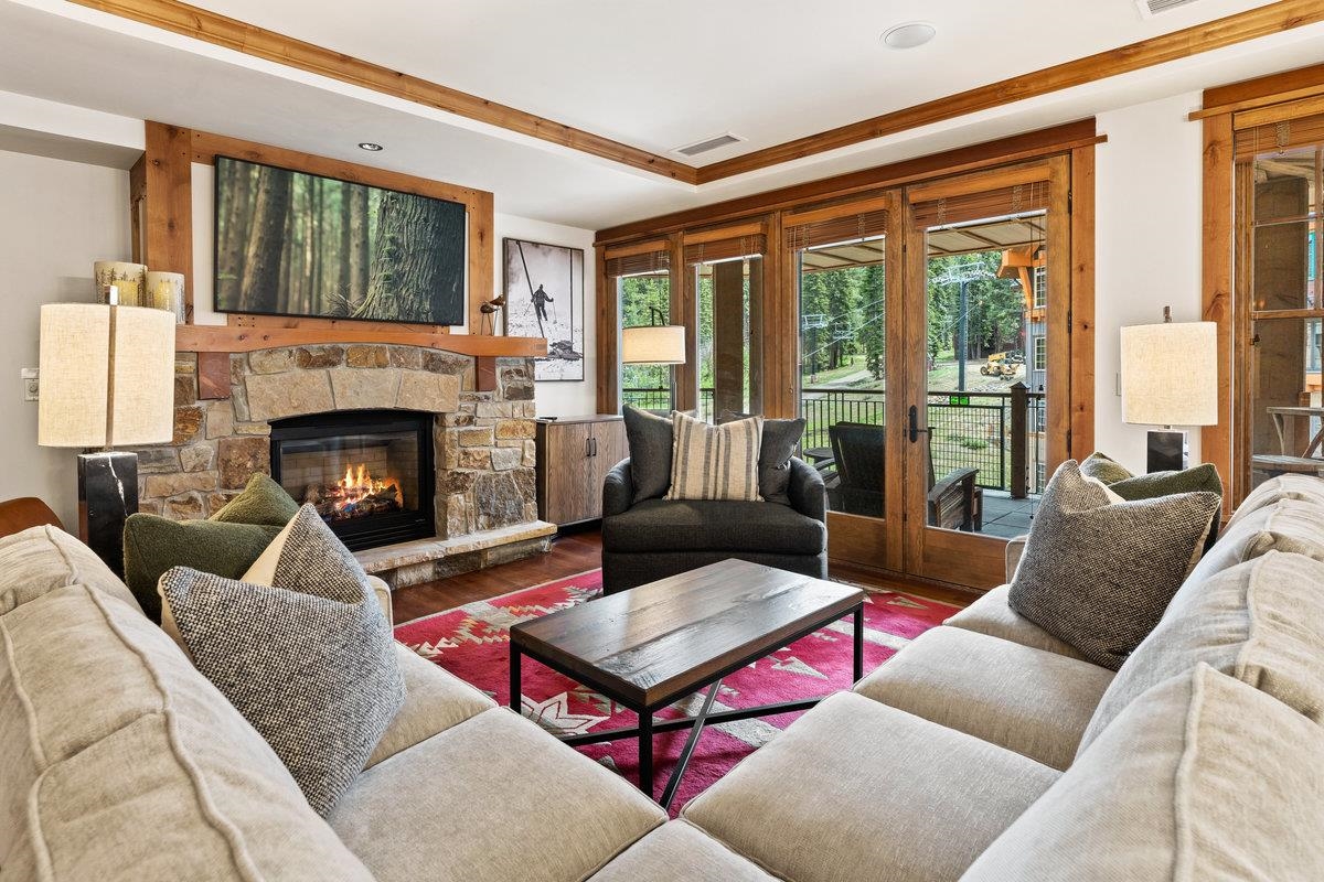 a living room with furniture fireplace and a large window