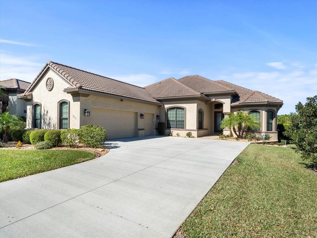 a front view of a house with a yard and garage