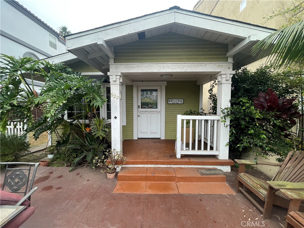 a view of a house with a small yard and plants