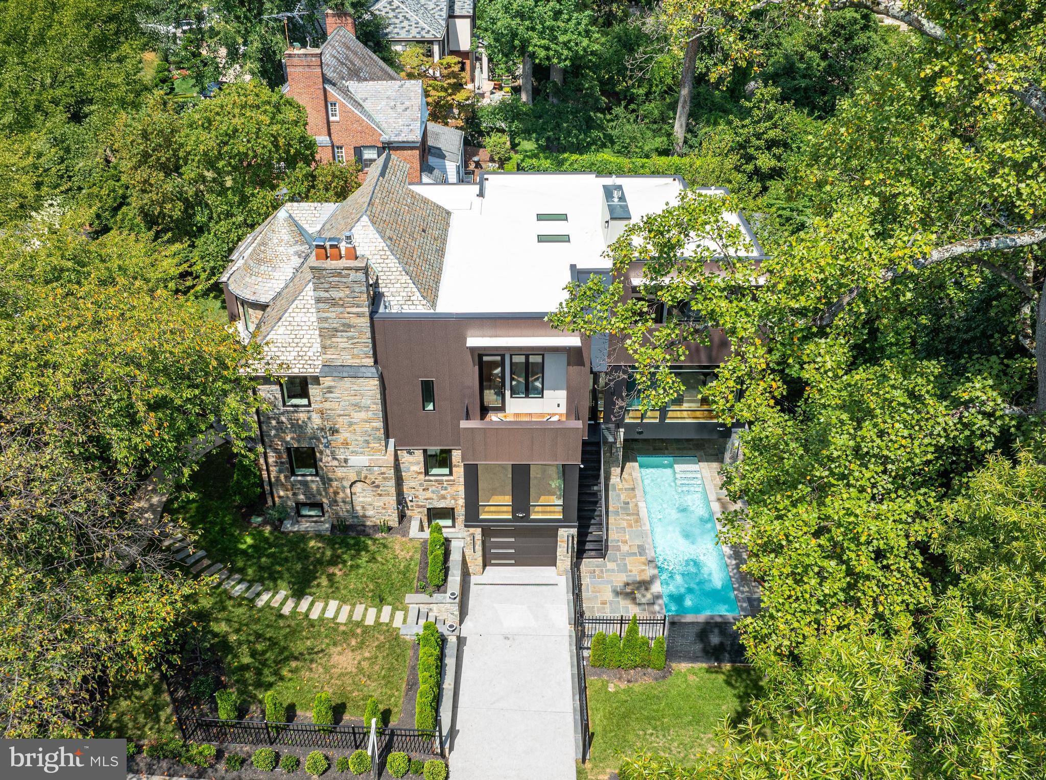 aerial view of a house with a yard and potted plants