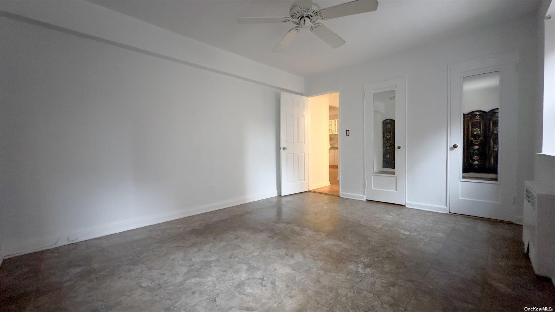 an empty room with closet and windows