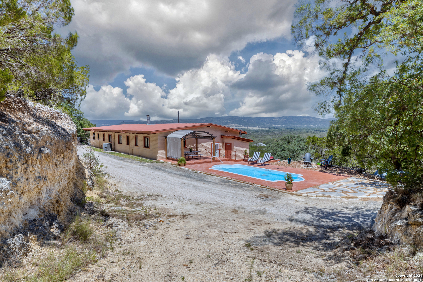 a view of a house with pool and a yard