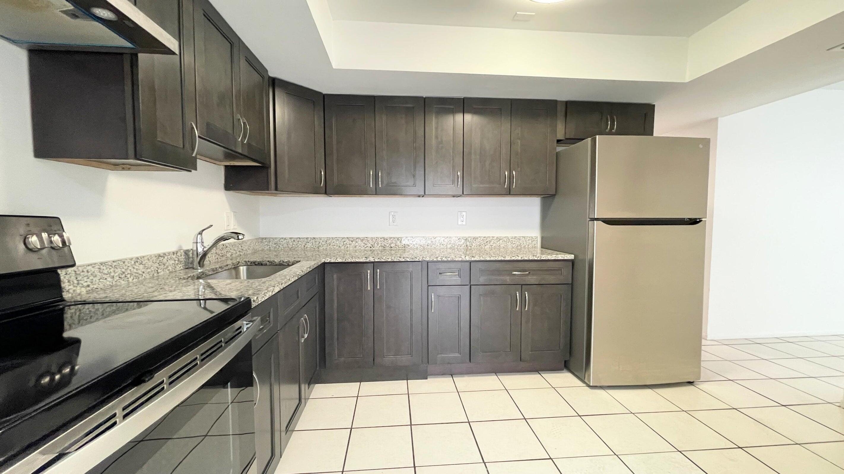 a kitchen with a sink and a refrigerator