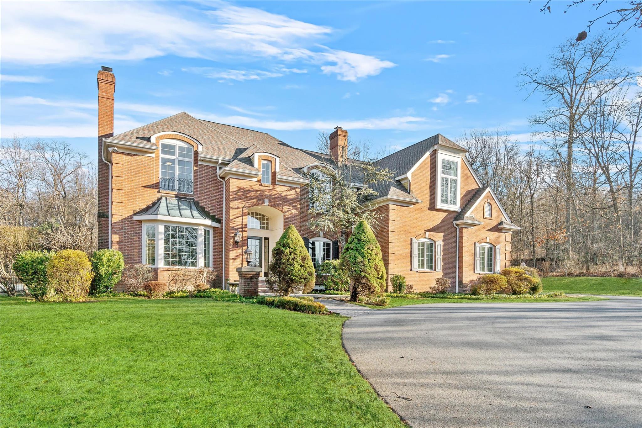 Elegant brick and circular driveway add to the appeal