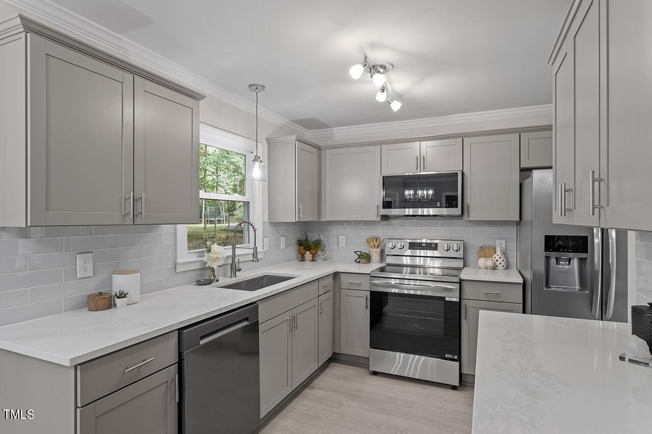 a kitchen with a sink stainless steel appliances and cabinets