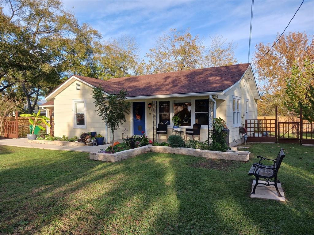 a view of a house with backyard porch and sitting area