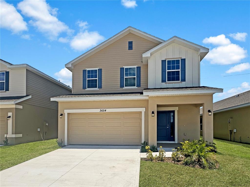 a front view of a house with a yard and garage