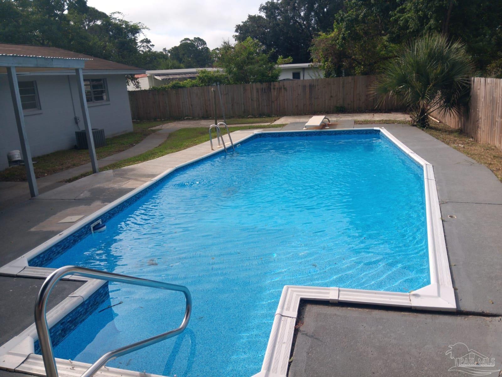 a view of a backyard with a small pool