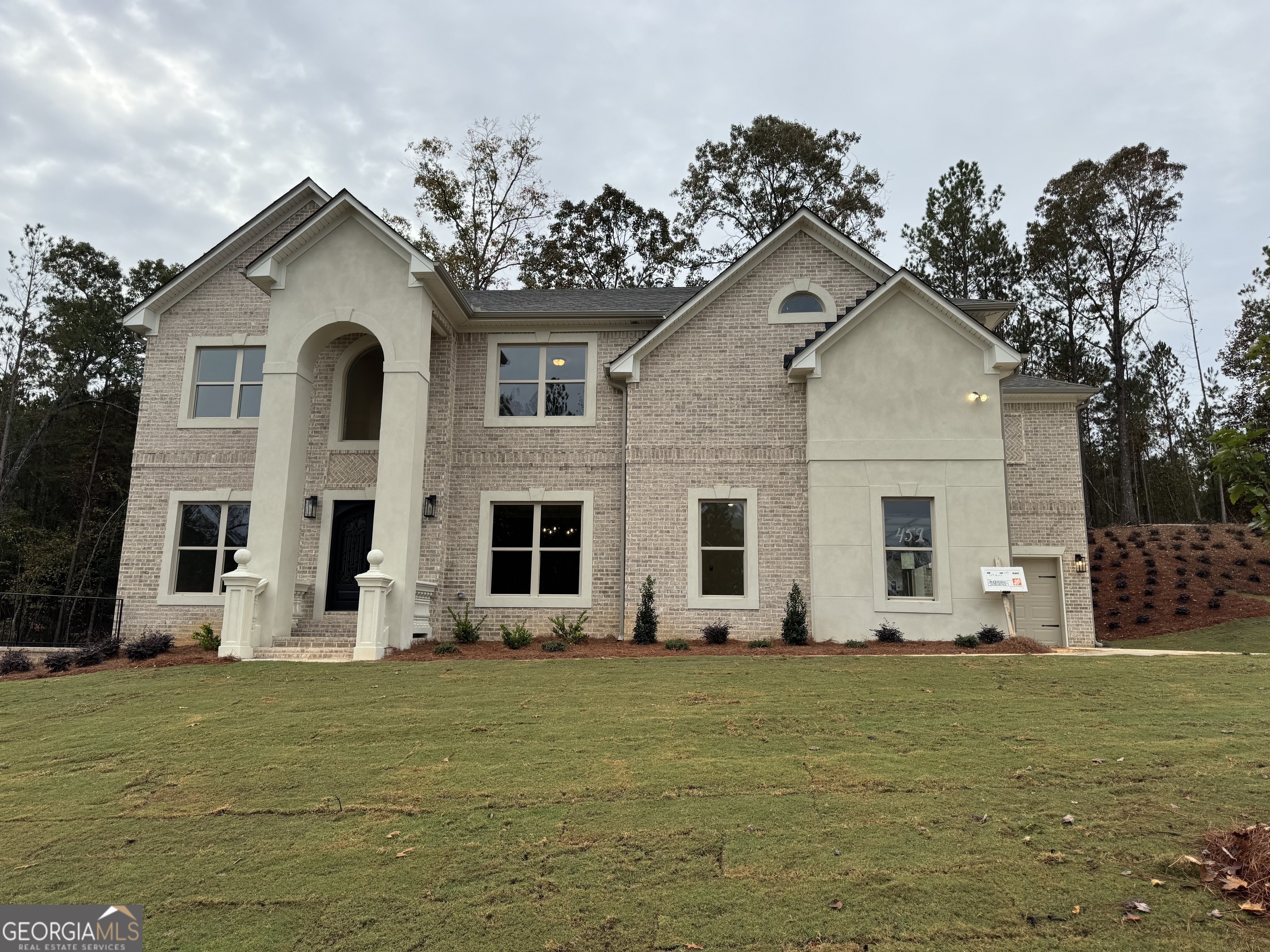 a front view of house with yard and green space