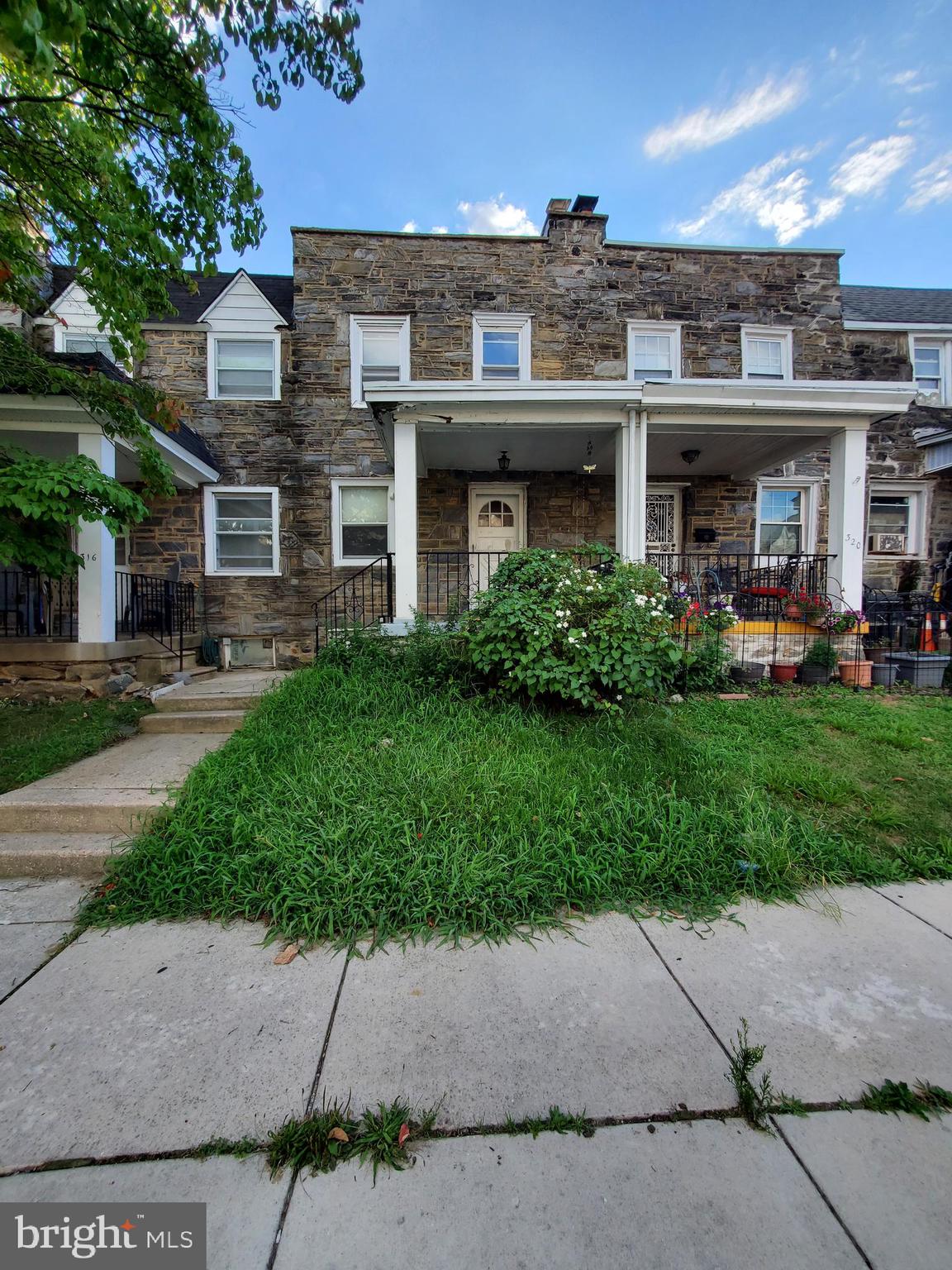 a front view of a building with a garden