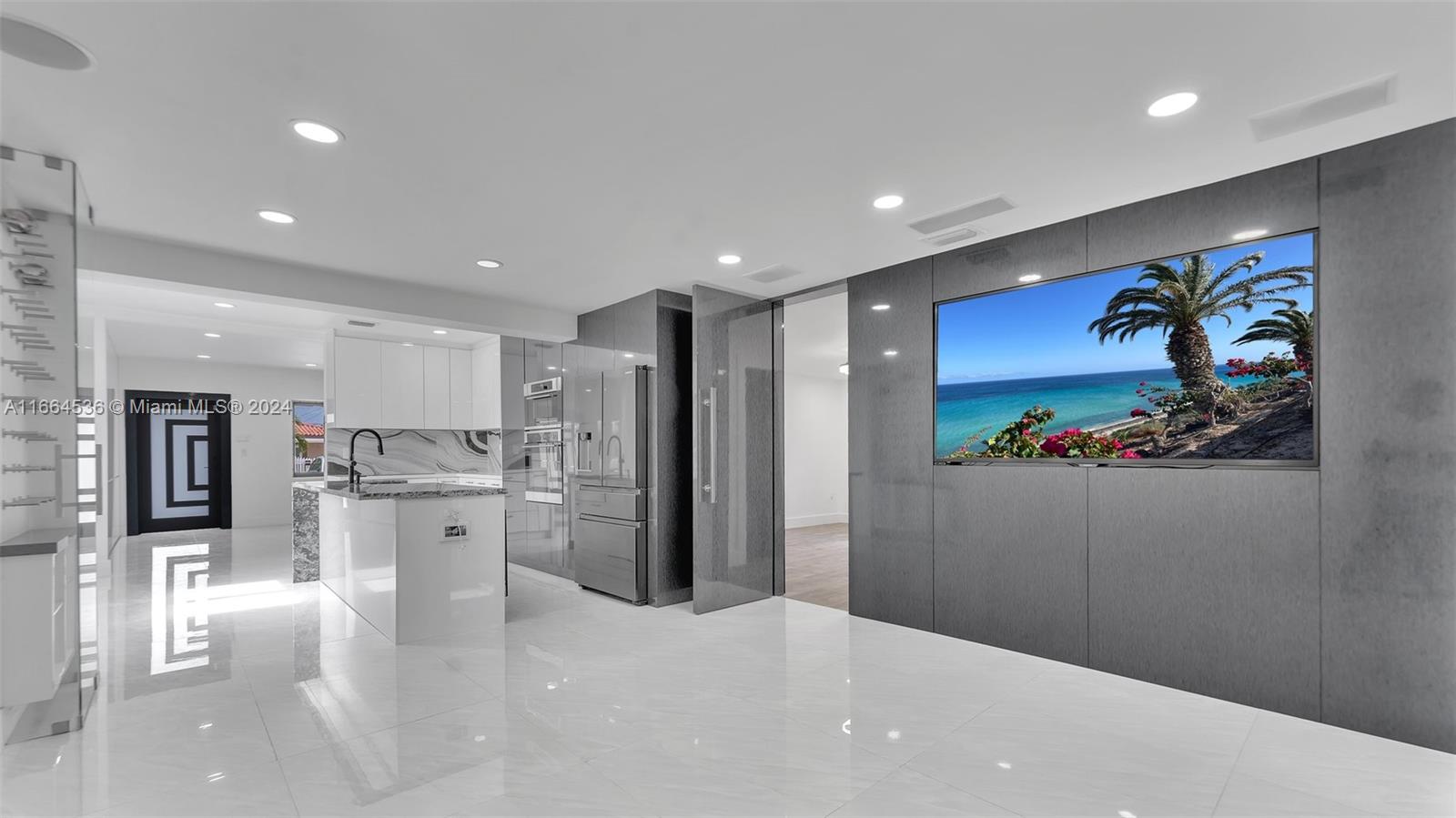 a kitchen with stainless steel appliances kitchen island granite countertop a refrigerator and a sink