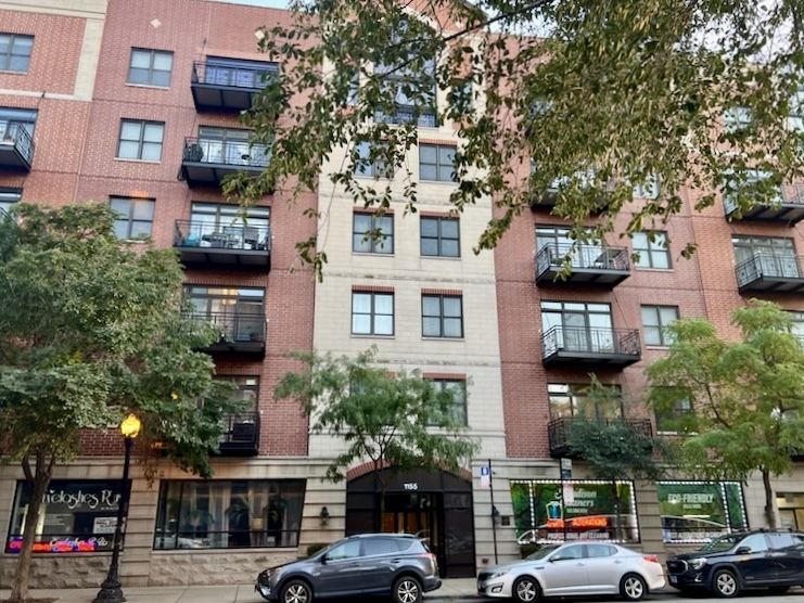 a view of a cars park in front of a building