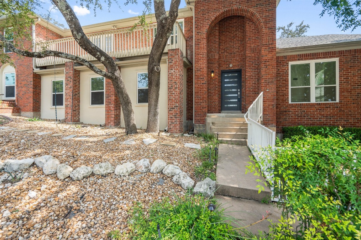 a front view of a house with garden