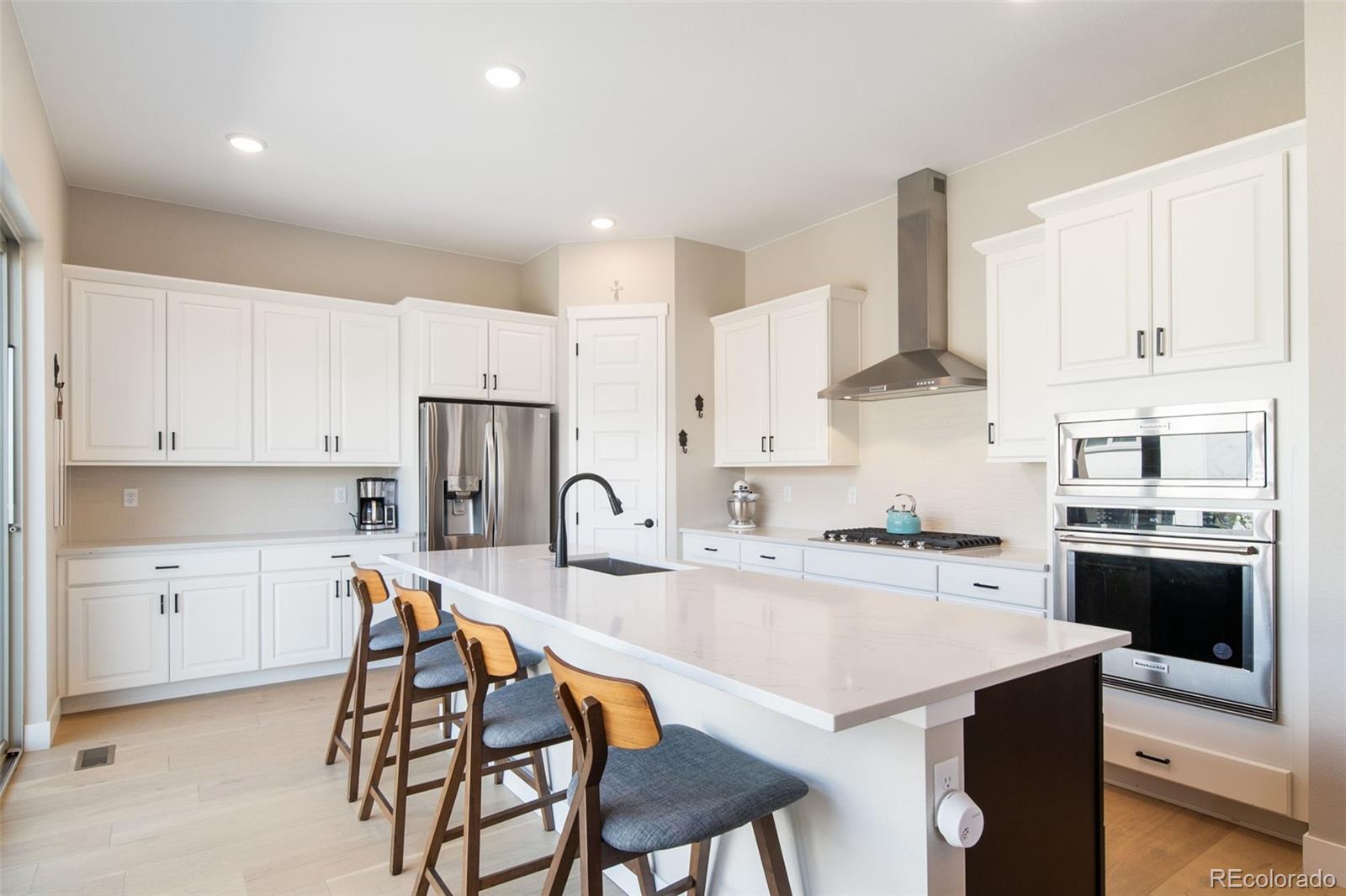 a kitchen that has a lot of cabinets in it with appliances and cabinets