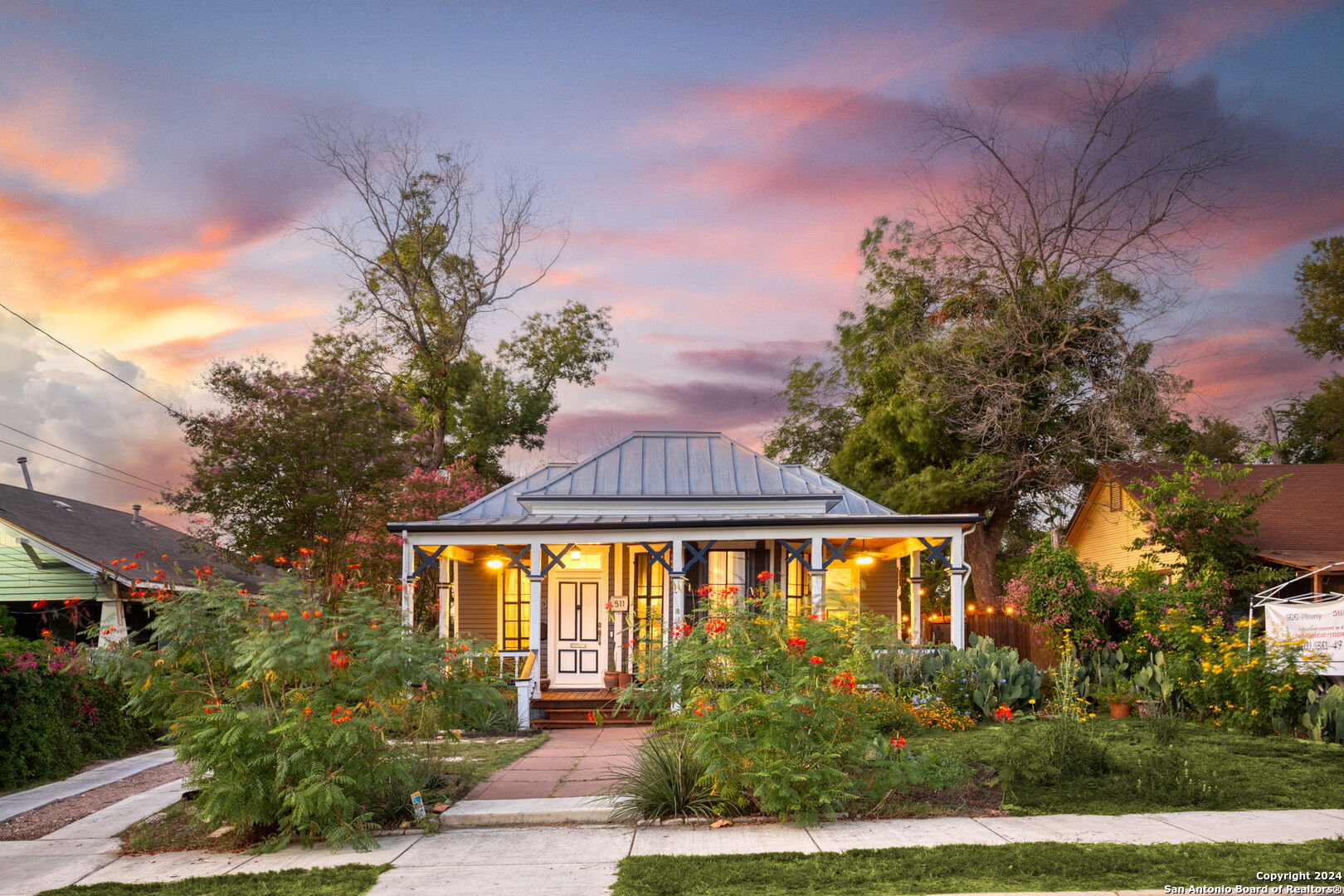 a front view of a house with a garden