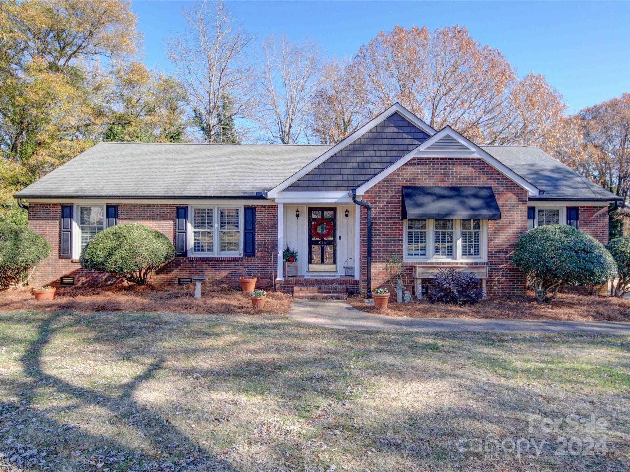 a front view of a house with yard and porch