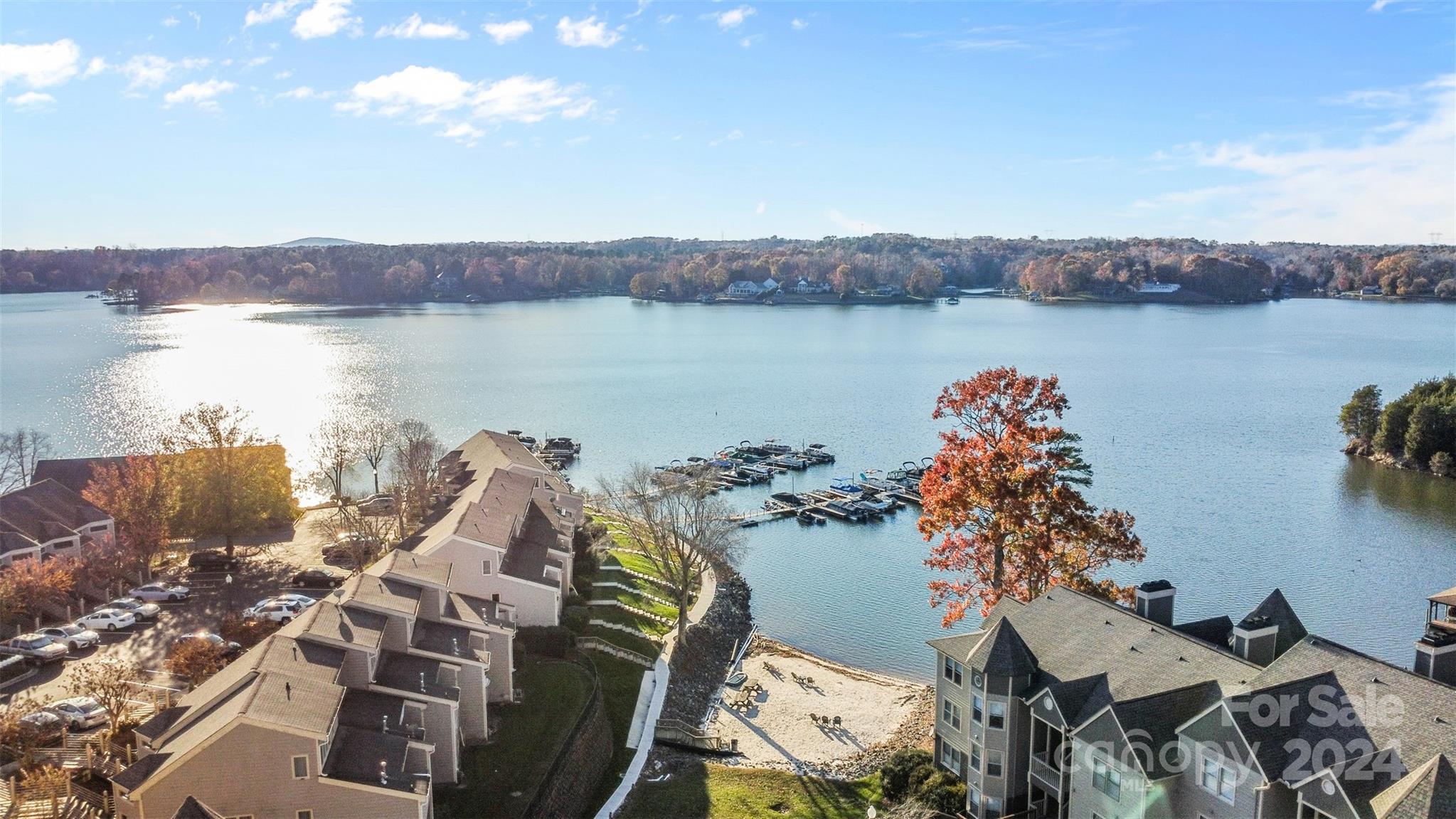 an aerial view of a house with outdoor space and lake view in back