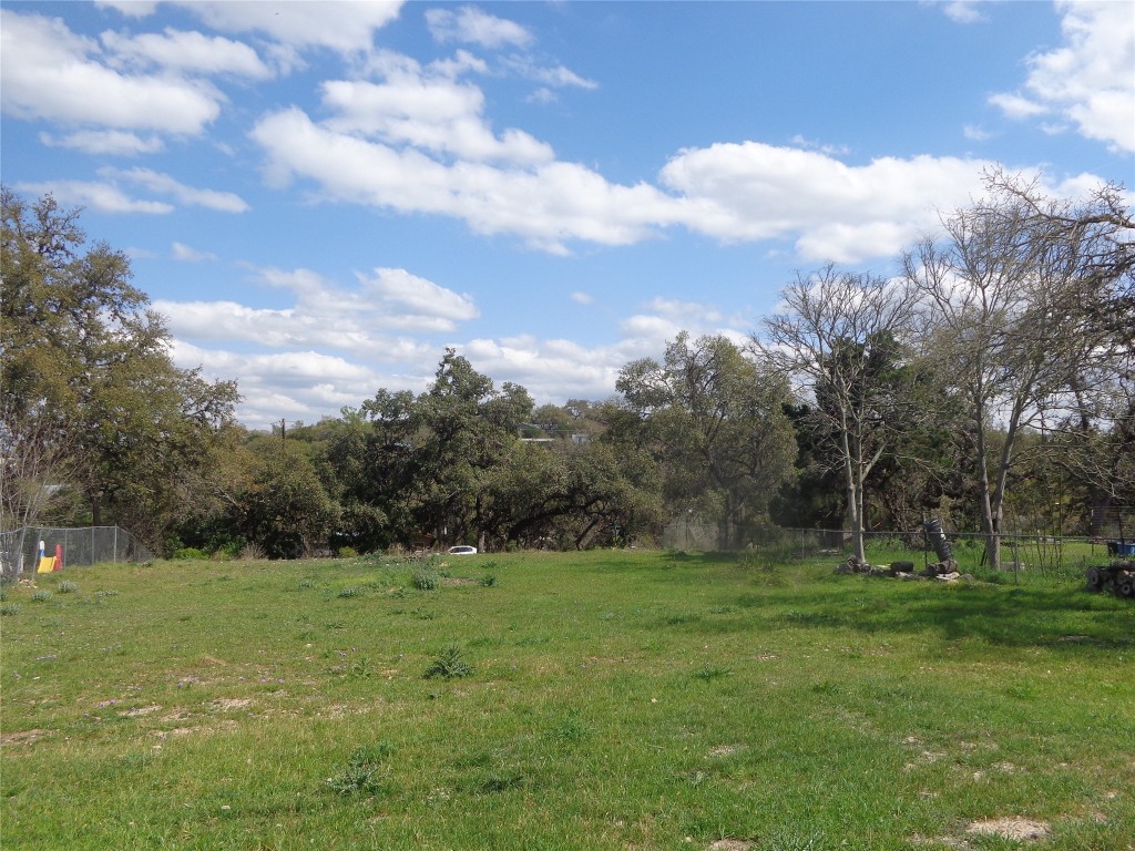 a view of a green field with wooden fence