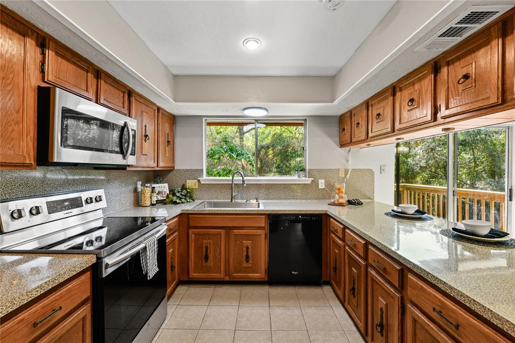 a kitchen with a sink stove top oven and microwave