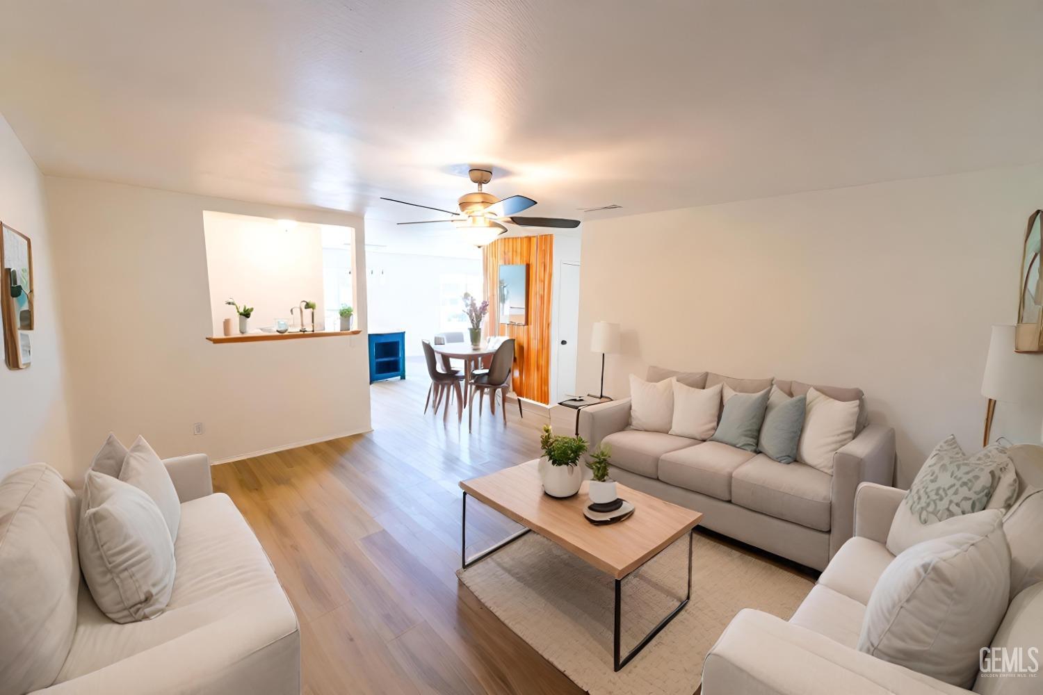 a living room with furniture and wooden floor