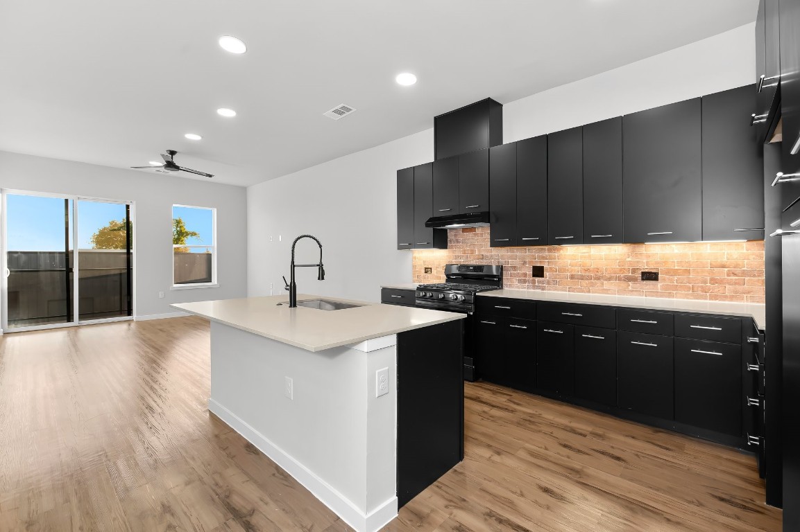 a kitchen with a sink and cabinets