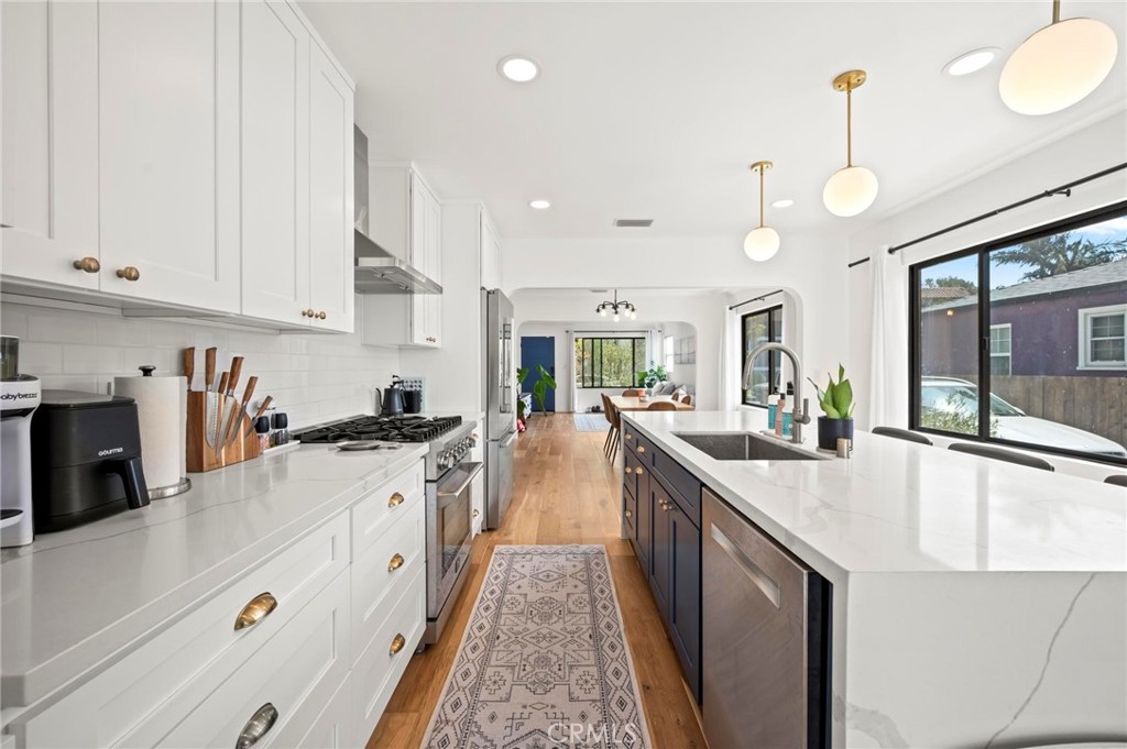 a kitchen with cabinets a sink and appliances