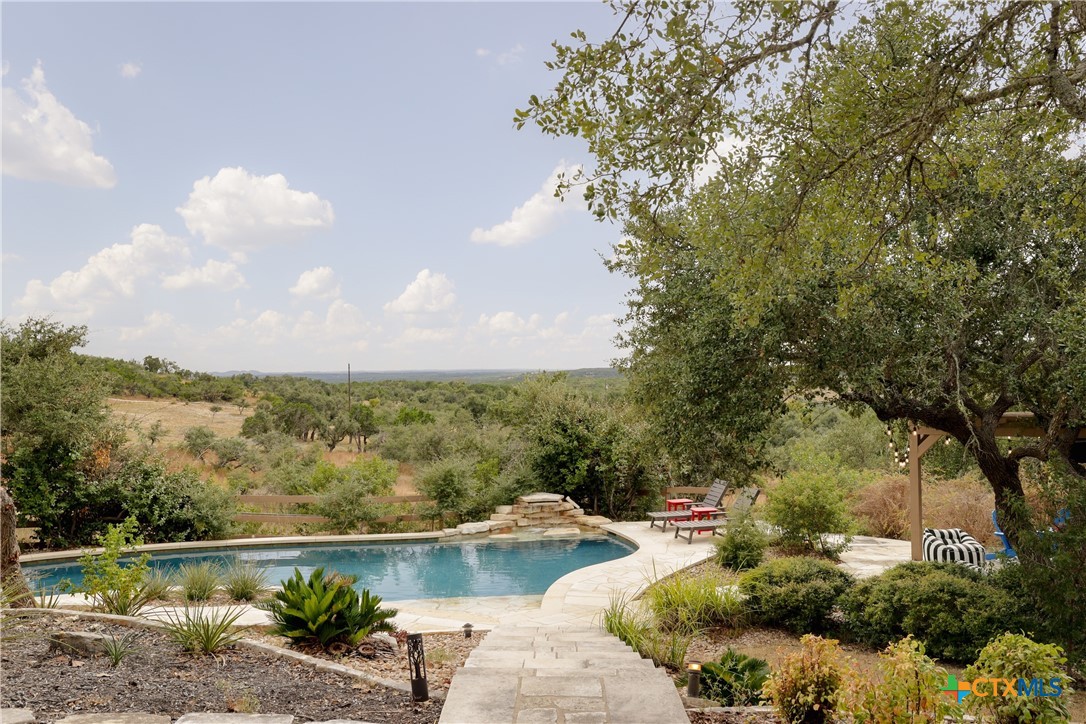 a view of a swimming pool with a yard